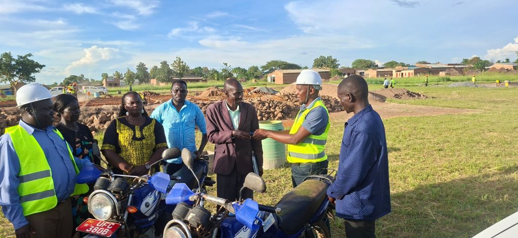 The Hunger project officer handing over two motorcycles to CAO